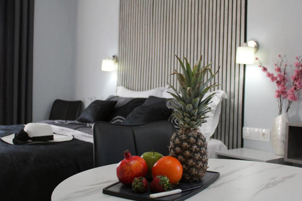 a tray of fruit on a table in a hotel room at Comfy Apartments Center in Nikiti