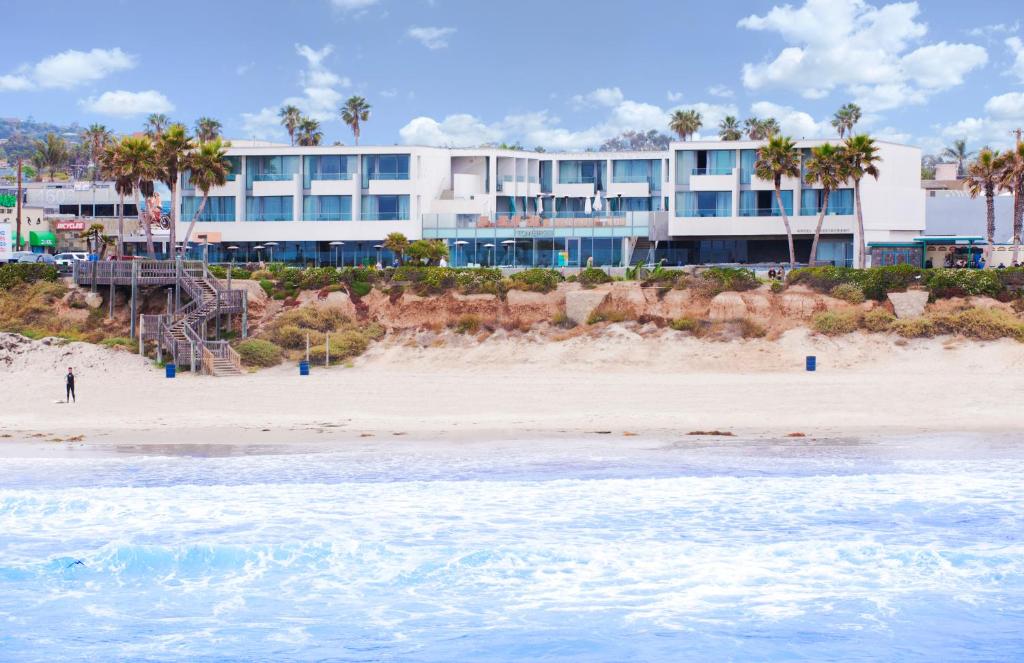 a large building on the beach with the ocean at Tower 23 Hotel in San Diego