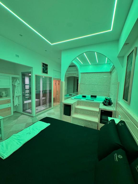 a bathroom with a bed and a tub in a room at San Domenico Dimora e Benessere in Putignano