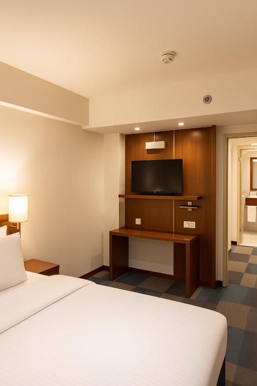 A bed or beds in a room at Taxim Express Bosphorus Hotel