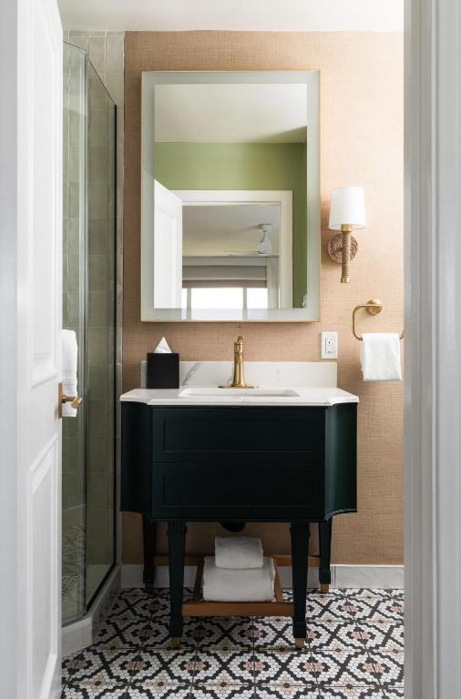 a bathroom with a black sink and a mirror at The Milo in Santa Barbara