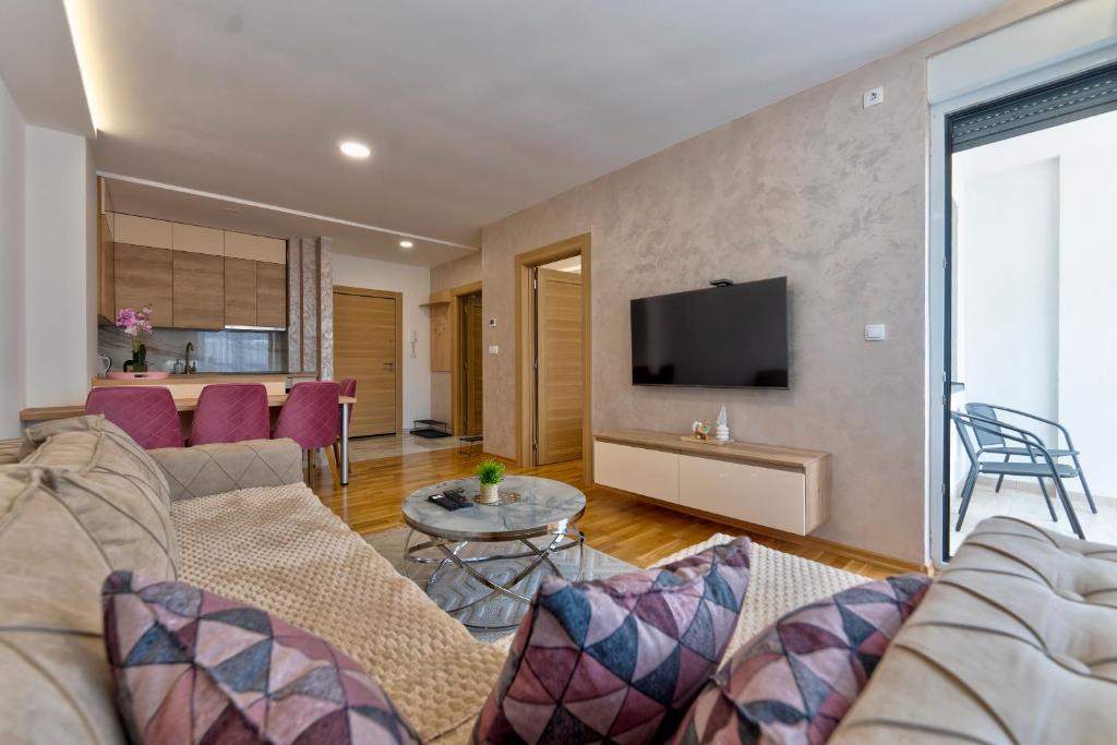 a living room with a couch and a tv at Vip Bogic 58 in Zlatibor