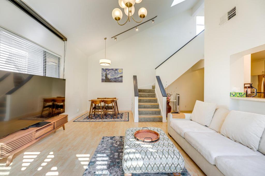 a living room with a white couch and a table at Pool and Trail Access On-Site Barton Creek Condo! in Austin