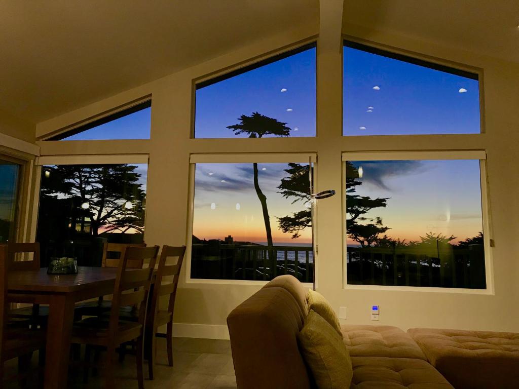a living room with a large window with a view of the sunset at Cambria Park Shores in Cambria