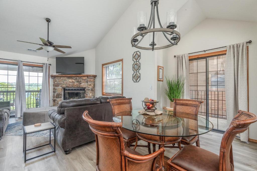 a living room with a glass table and chairs at 2BR Village At Indian Point 1112 near SDC - Free Tickets Daily up to $500 in Branson