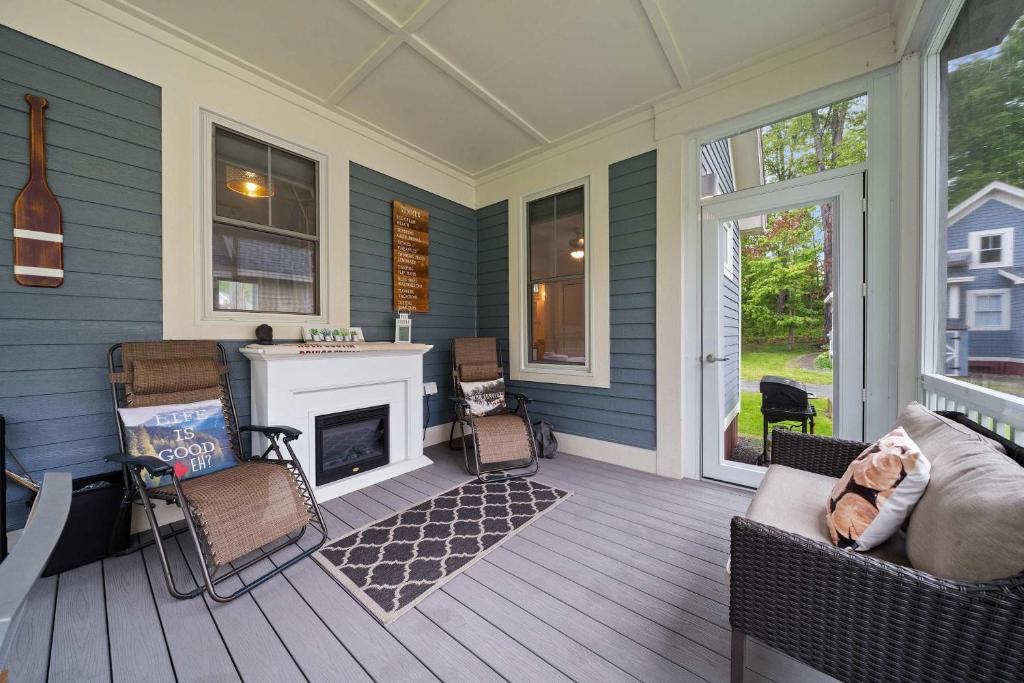 a screened porch with a fireplace on a house at The Tamarack - 11 Hollow in Cherry Valley