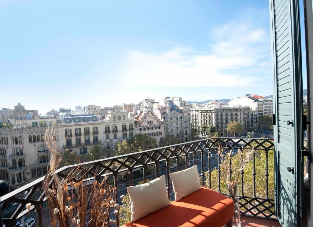 a balcony with a couch and a view of a city at You Stylish The Most Luxury Apartment in Barcelona