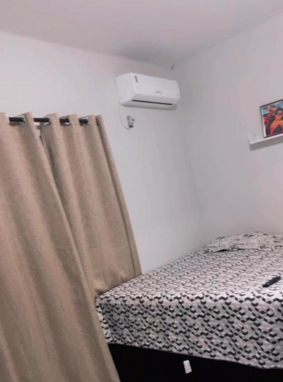 a bed with a curtain in a room at Apartamento Mobiliado bem localizado na Augusto Montenegro in Belém