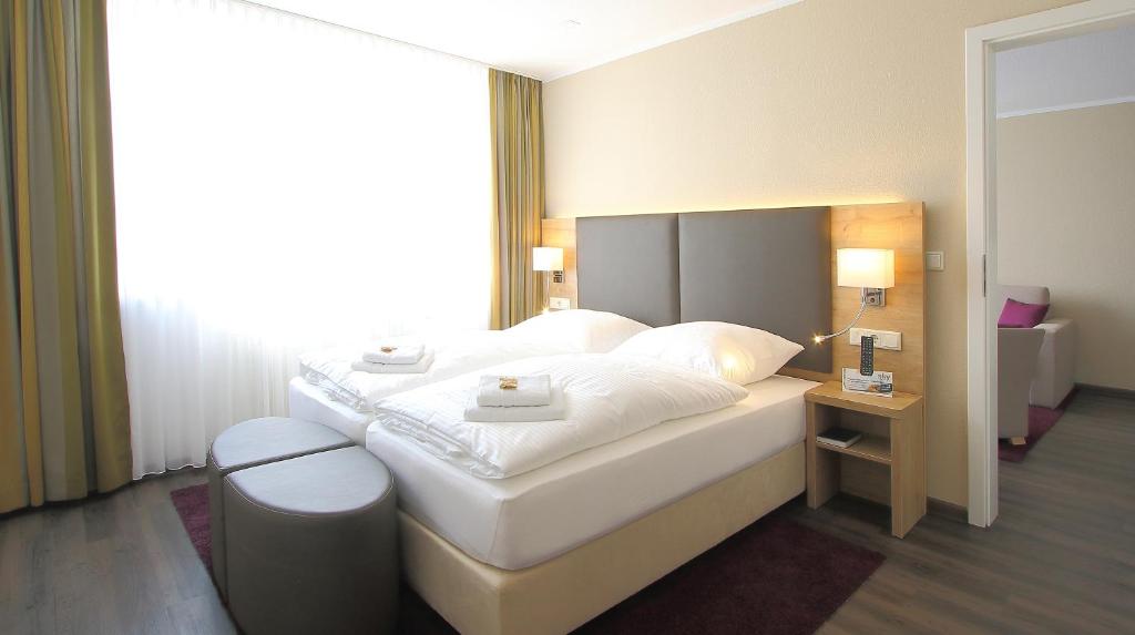Postel nebo postele na pokoji v ubytování Akzent Hotel Am Burgholz