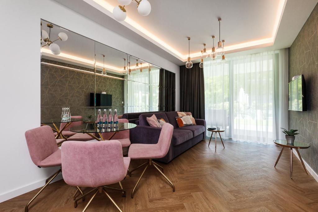 a living room with a couch and a table at Baltic Amber Apartment in Stegna