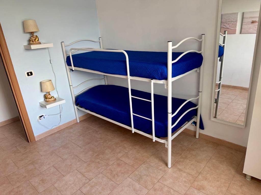 A bed or beds in a room at La Corte di Nunu'