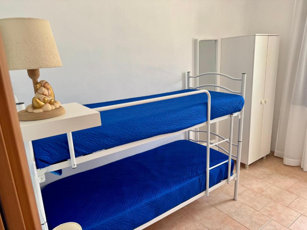 A bed or beds in a room at La Corte di Nunu'