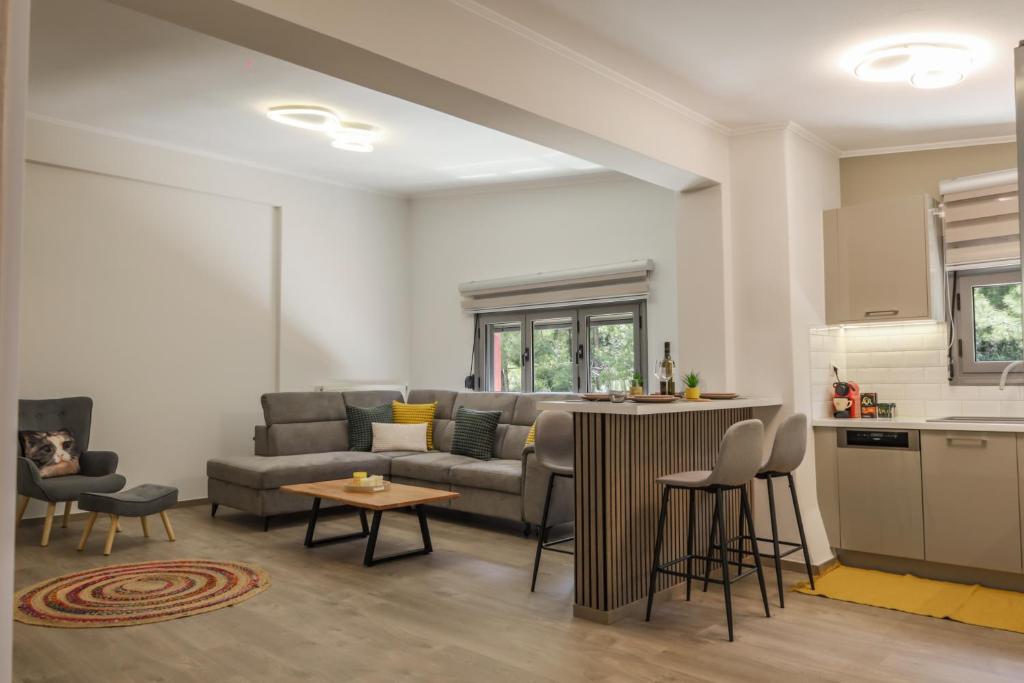 a living room with a couch and a kitchen at Sunny Loft in Igoumenitsa