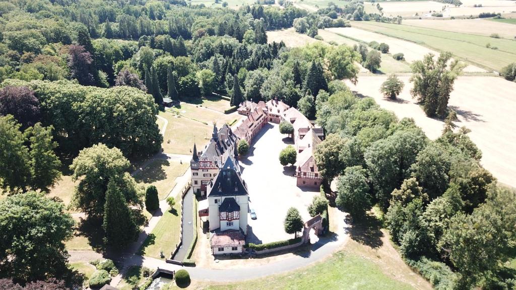 an aerial view of a castle in the trees at Historische Mühle am Schloss in Amöneburg