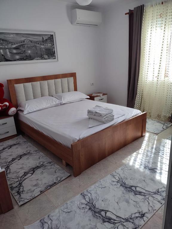 a bedroom with a large bed in a room at Guest house Eloid in Berat