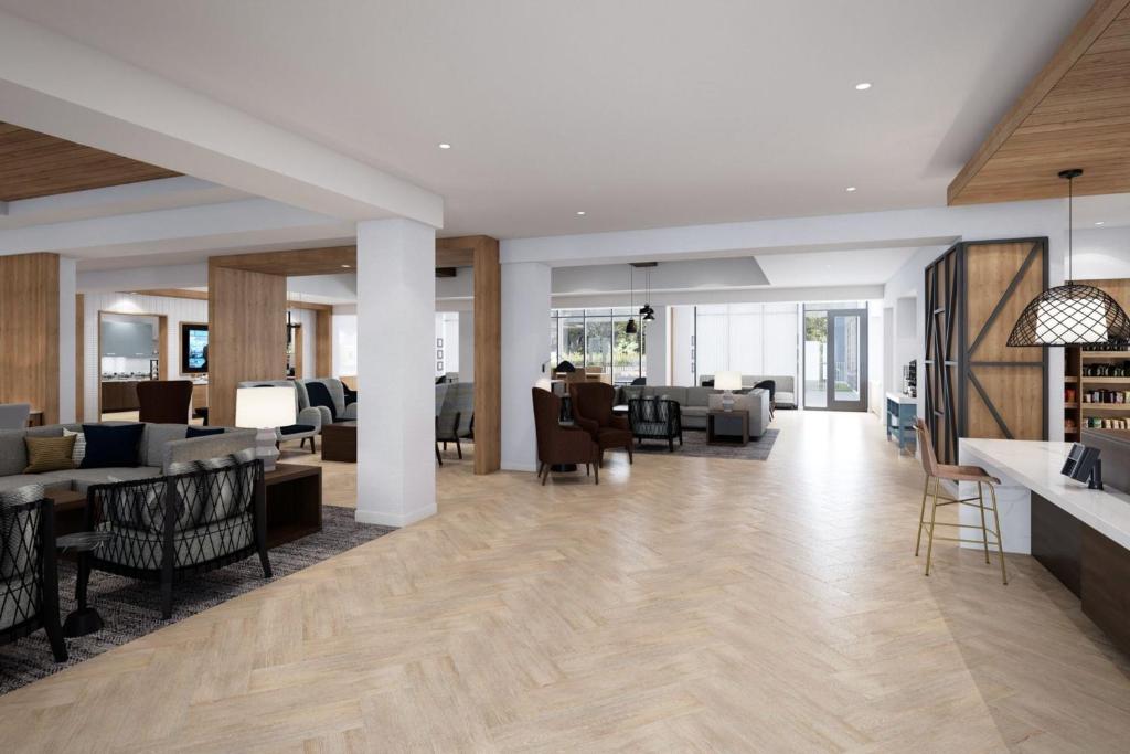 a lobby of a building with tables and chairs at Staybridge Suites Kincardine Southeast in Kincardine