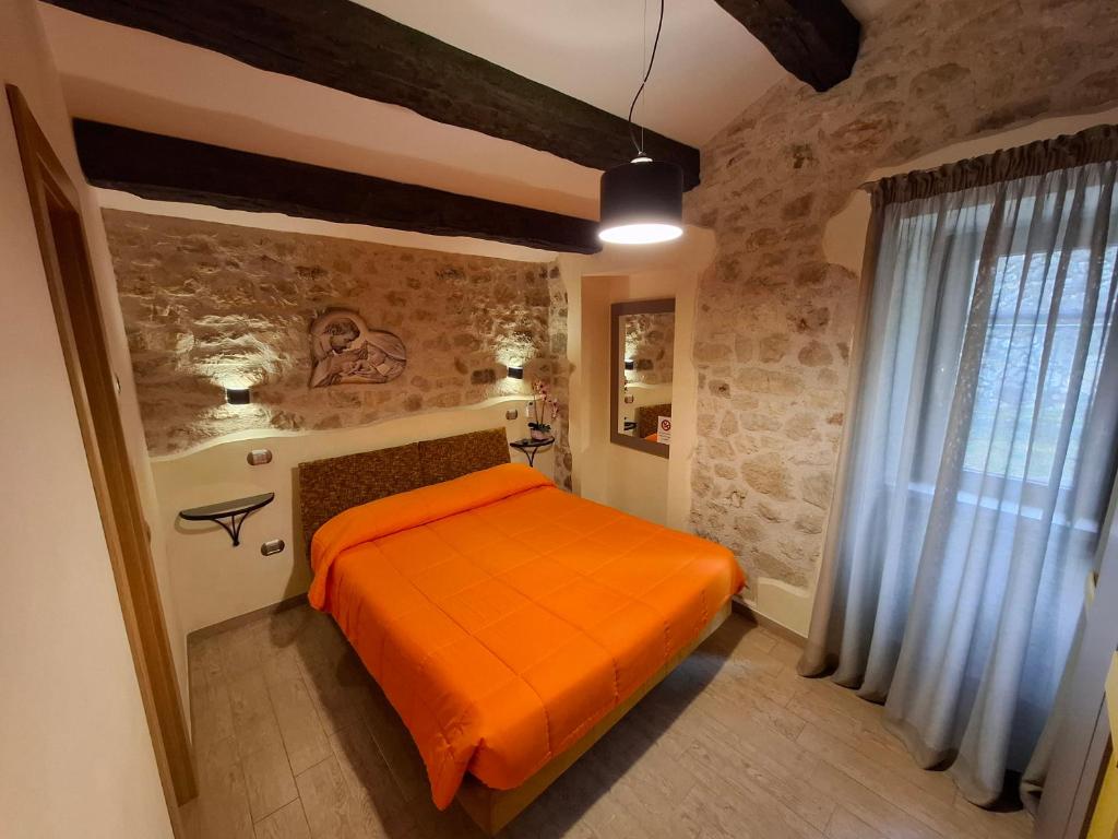 Postel nebo postele na pokoji v ubytování Antico Mulino di Cascia