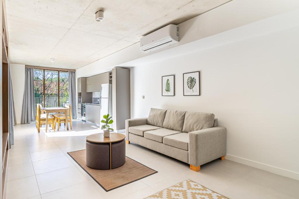 a living room with a couch and a table at Deluxe Recoleta Apartments - By Magno in Buenos Aires
