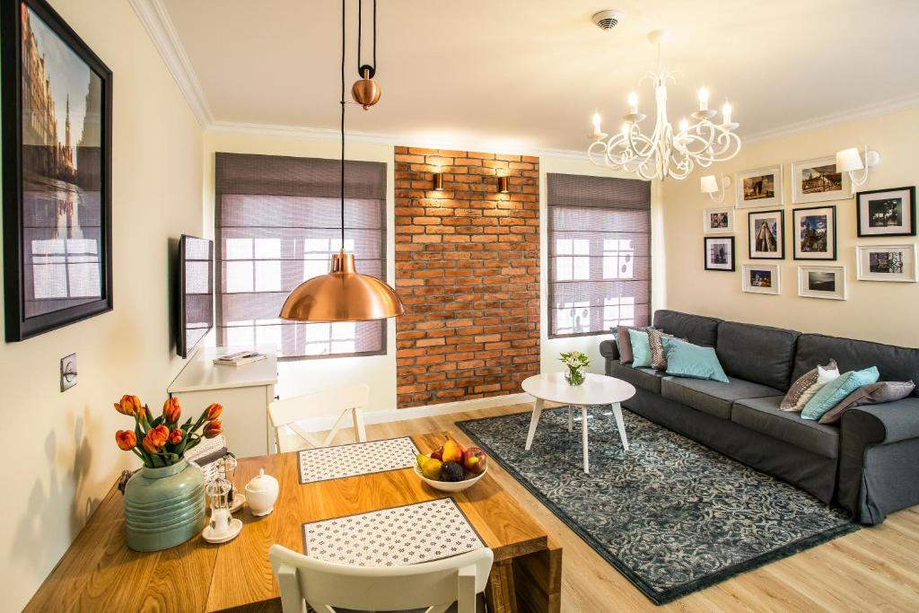 a living room with a couch and a table at Right Stay in Gdańsk