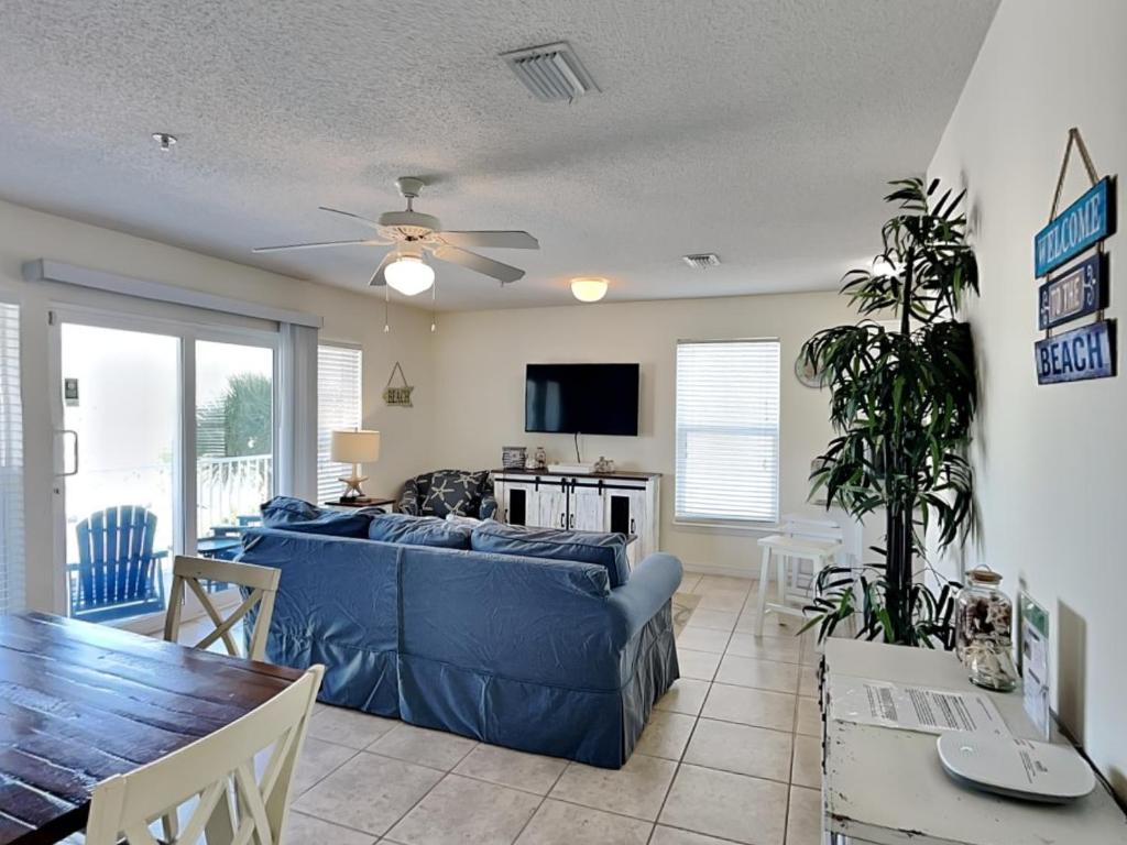 a living room with a blue couch and a table at Gulf Island #521 in Navarre
