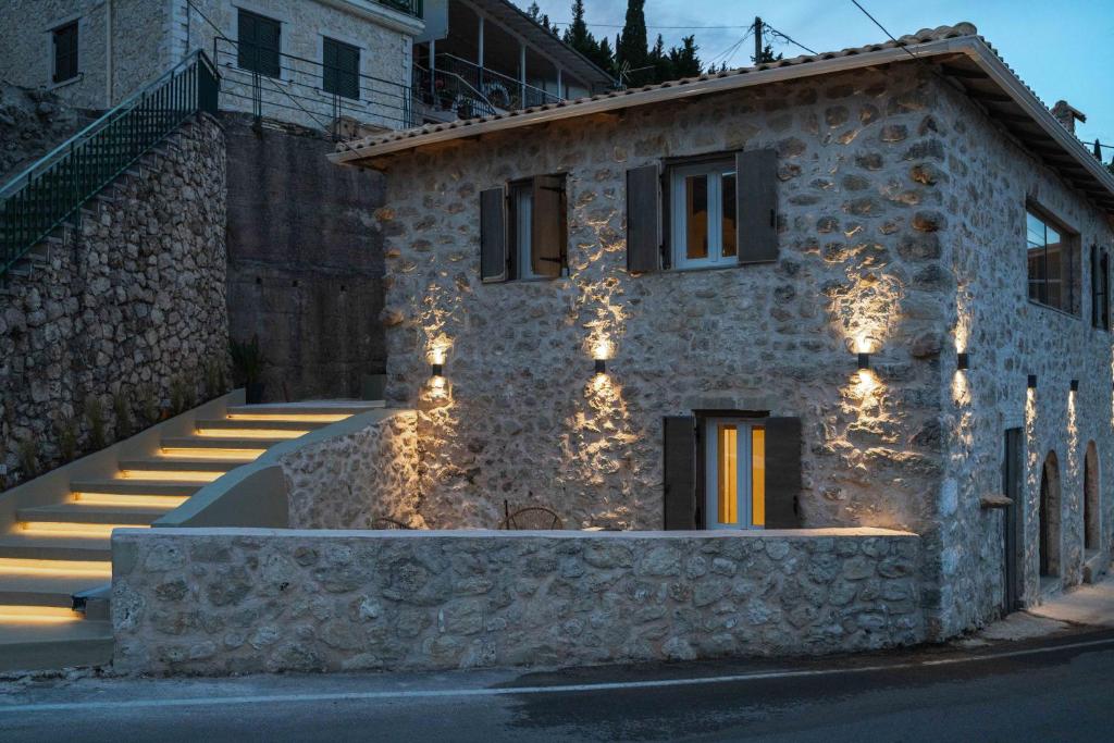 a stone house with lights on the side of it at Amalia Casa Lefkada in Pigadhisánoi