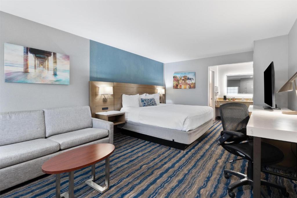 a hotel room with a bed and a couch and a desk at Best Western San Diego/Miramar Hotel in Miramar