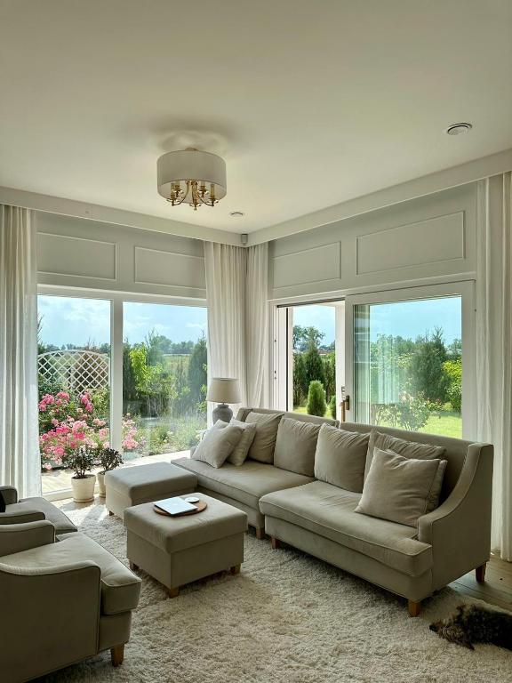 a living room with a couch and a large window at Villa Mare in Gdańsk