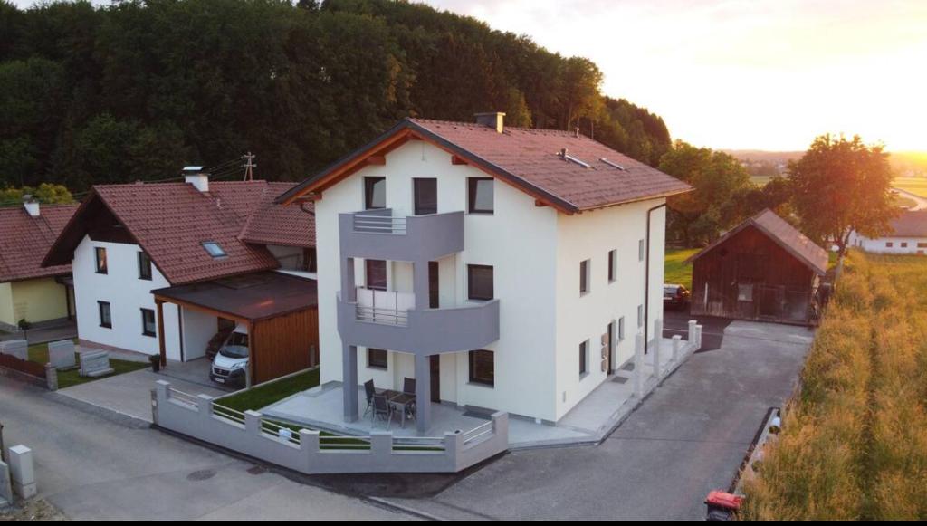 a white house with a red roof at SUNSET RESIDENCE Attersee 