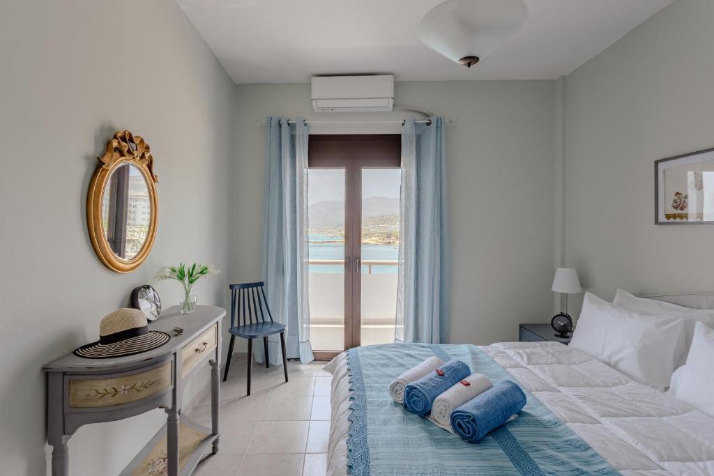 a bedroom with a bed and a desk and a window at Eclectic Vintage Apartment- Sea View Perfection, Hersonissos, Crete in Limín Khersonísou