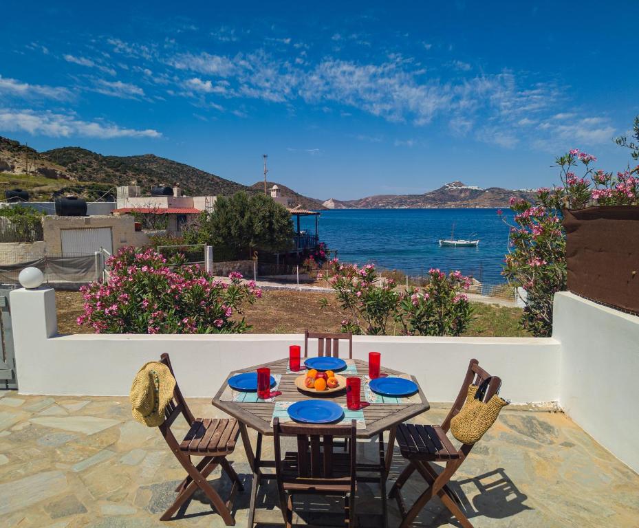 a table and chairs on a patio with a view of the ocean at Manos' Dream in Empourios