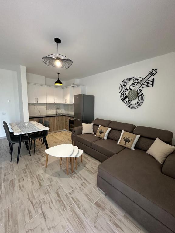a living room with a couch and a table at Casa Del Mar 2 in Shëngjin