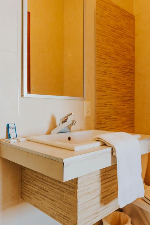 Postel nebo postele na pokoji v ubytování Casa Chetumal Hotel