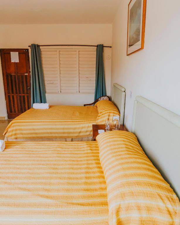 Postel nebo postele na pokoji v ubytování Casa Chetumal Hotel