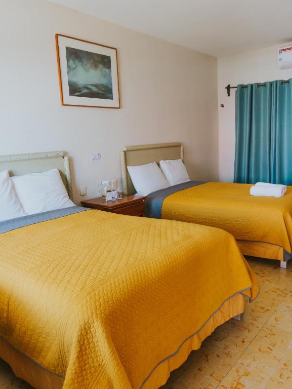 Postel nebo postele na pokoji v ubytování Casa Chetumal Hotel