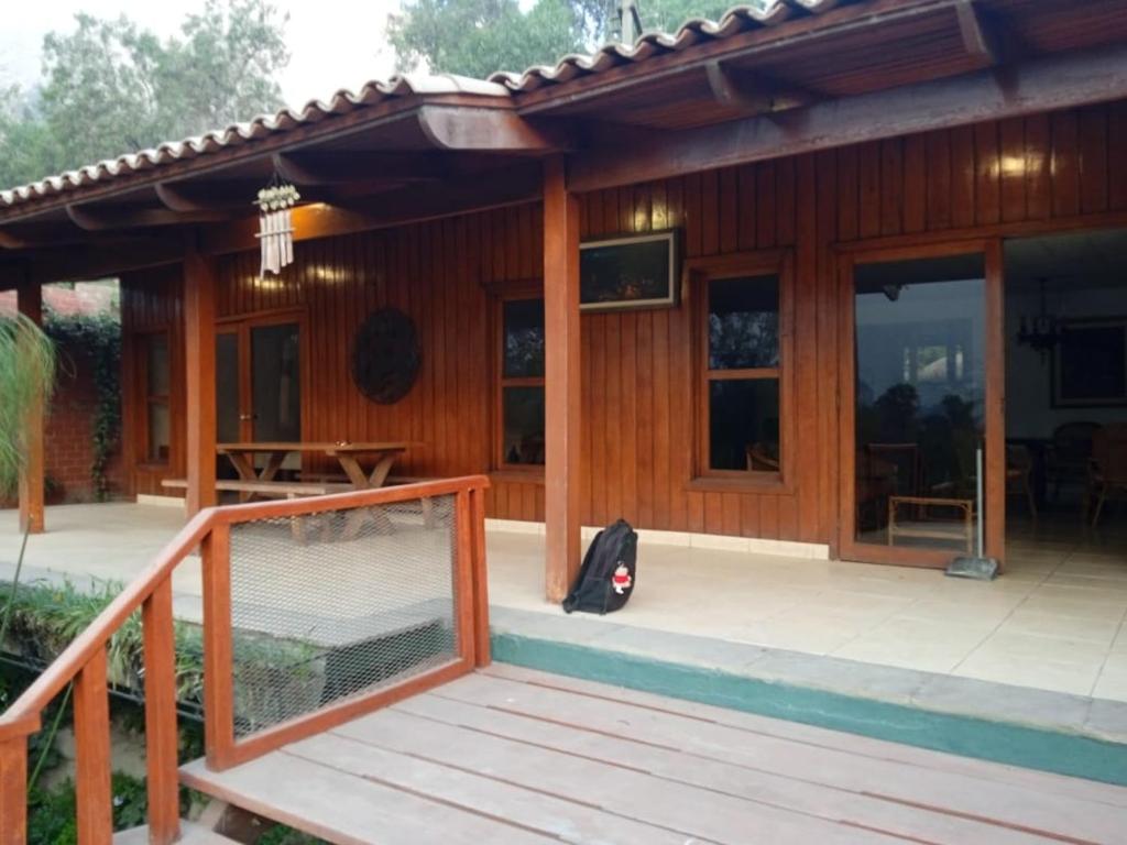 a wooden house with a porch and a deck at Villa Della Pietra in Chaclacayo