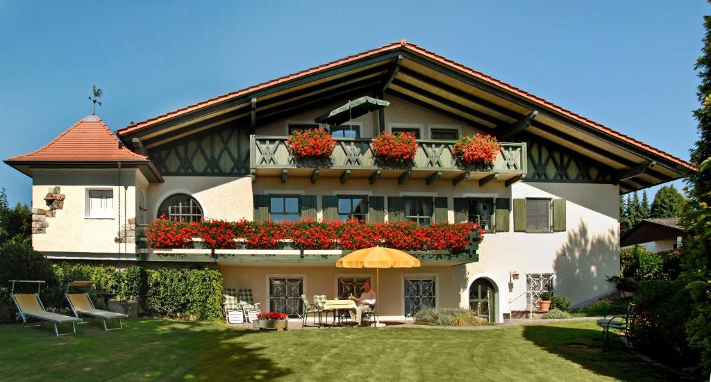 a large house with flower boxes on the balcony at Häusl im Park in Bad Birnbach