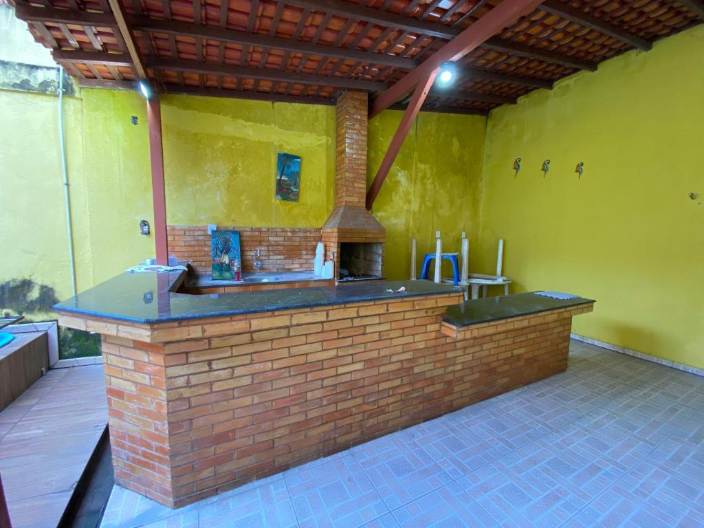 an outdoor kitchen with a brick counter in a building at Casa Bio - Your place in COP 30 - Completa in Belém