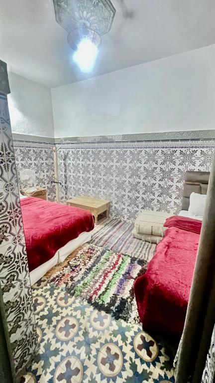 A bed or beds in a room at Riad Dar Lokman