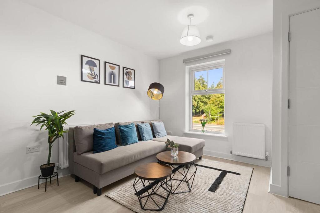 a living room with a couch and a table at Modern 2-Bed House 10-min to Leeds City Centre in Leeds