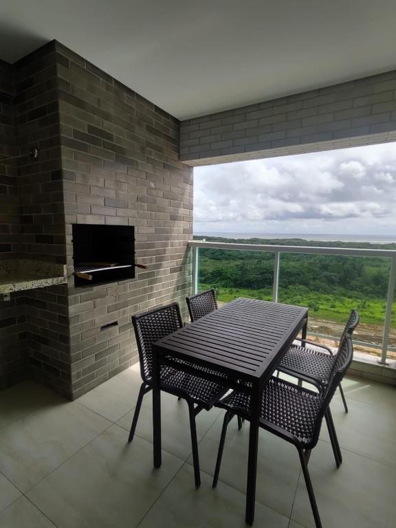 a dining room with a table and chairs and a fireplace at Salinas Park Resort in Salinópolis