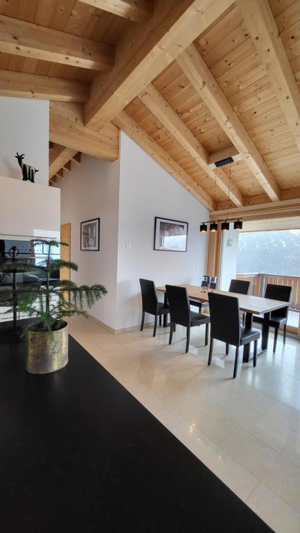 a dining room with a table and chairs at Chasa Scandella Apartment Monica in Sent