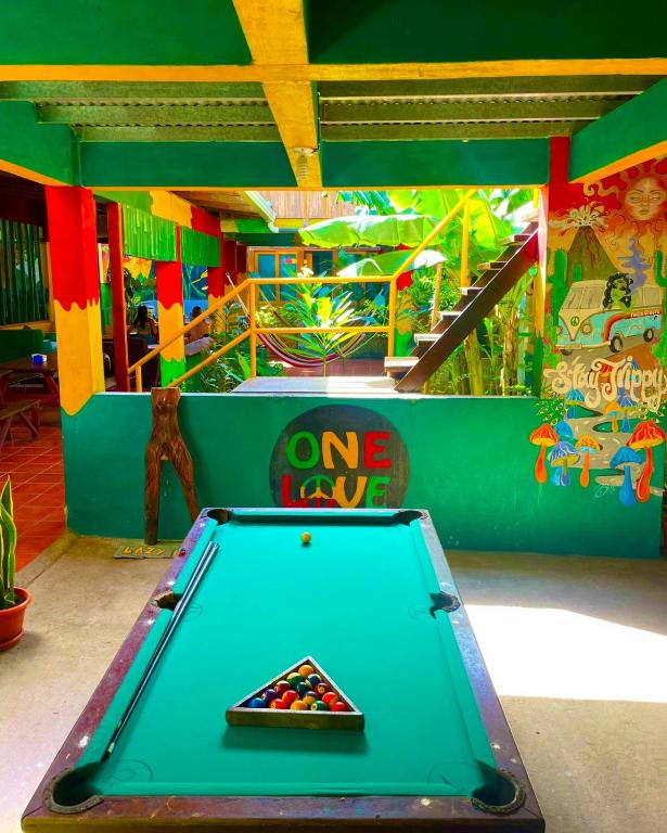 a pool table in a childrens play area at Lazy Crab Hostel in Balgue