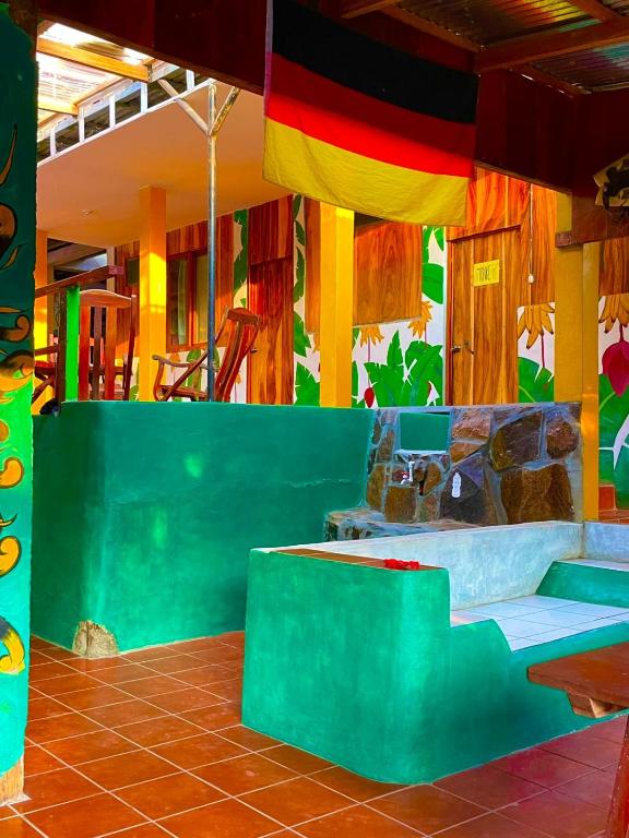 a room with colorful walls and a table and stairs at Lazy Crab Hostel in Balgue