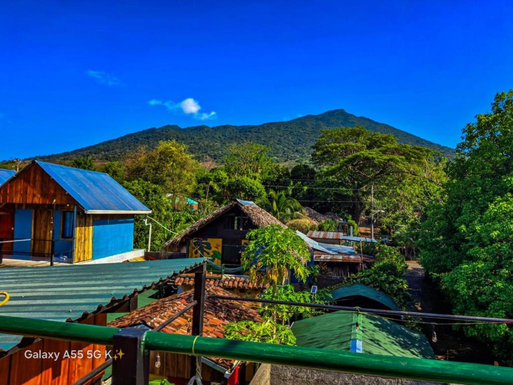a view of a village with mountains in the background at Lazy Crab Hostel in Balgue