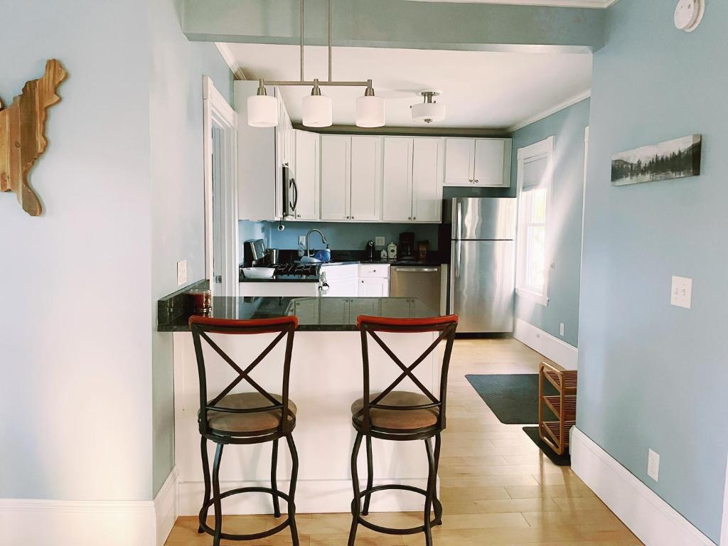 a kitchen with two bar stools in a room at Cozy 1Br Apt in Bangor