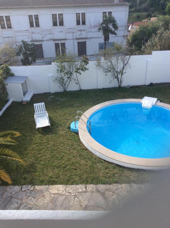 a large swimming pool in the yard of a house at Casa Dos Oliva in Alcobaça