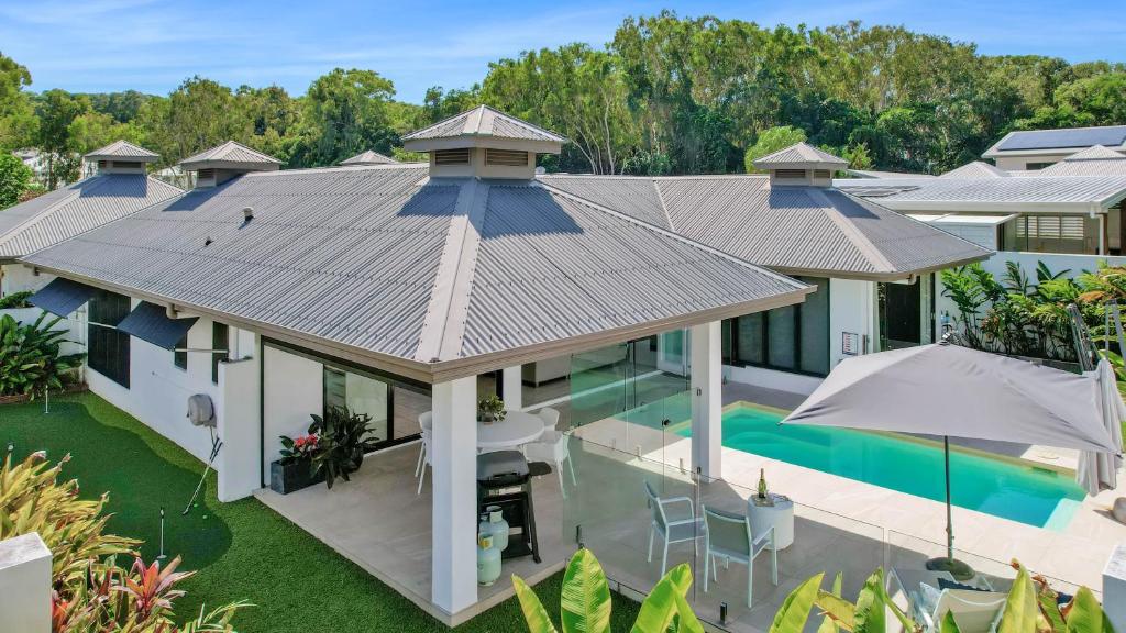 an aerial view of a house with a swimming pool at Pura Villa - Tropical Luxury Living in Palm Cove