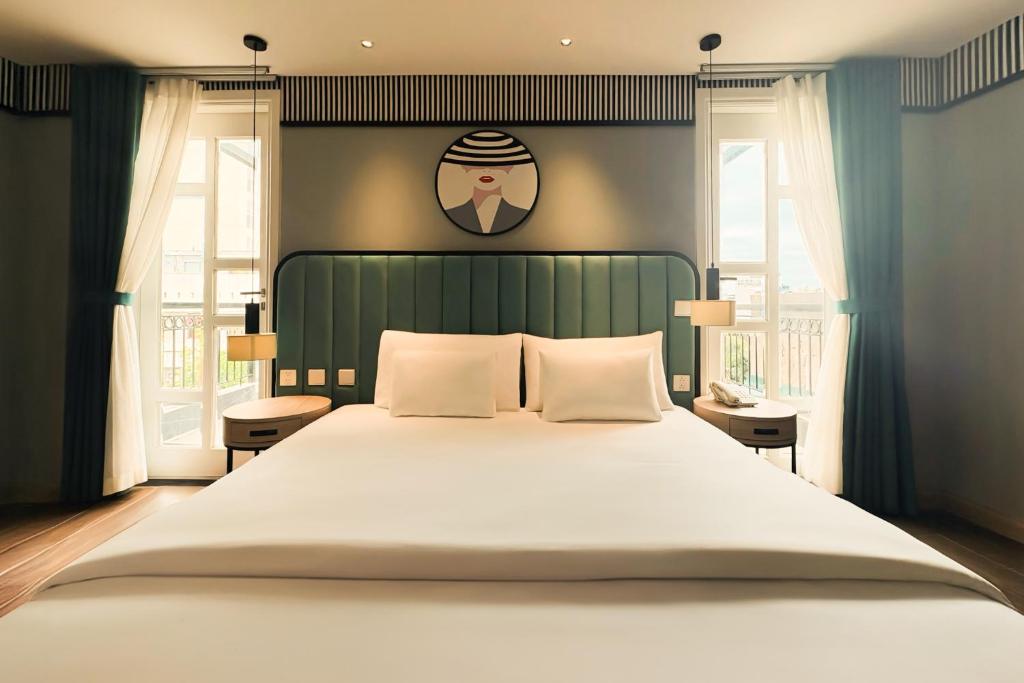 Postel nebo postele na pokoji v ubytování A25 Hotel - 130 Bà Triệu