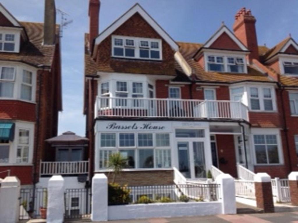 a house with a sign for the front of it at Bassets House in Eastbourne