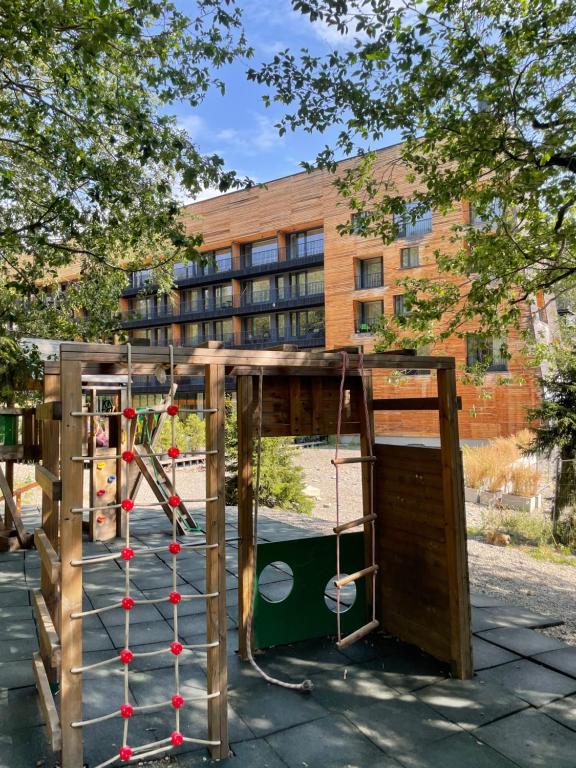 a playground in front of a building at Bakuriani Kokhta Apartments in Bakuriani